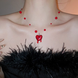 Detail of red heart drop pendant with crystal beads on a thin aesthetic necklace
