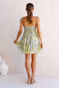 Detail view showing the back elastic smocking and floral layered skirt design