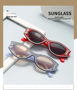Detail of rhinestone-encrusted cat-eye sunglasses with decorative round diamonds