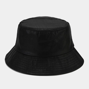Close-up of black bucket hat featuring vertical pleated texture and reinforced stitching