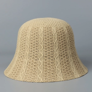 Detailed view of the breathable knitted pattern and cable texture on the beige bucket hat