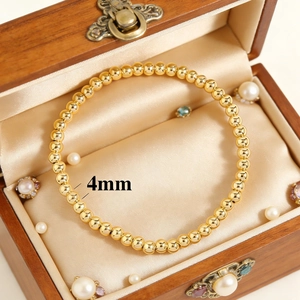 Elegant 18K gold-plated 4mm bead elastic bracelet displayed in a luxury jewelry box