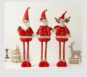 Detailed view of plush Christmas figures with retractable long legs in red and gold finish