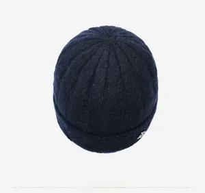 Top view showing dark blue ribbed knit beanie texture and triangle metal ornament