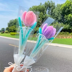Close-up of handmade pink and purple tulip flower bouquets in elegant clear gift wrapping