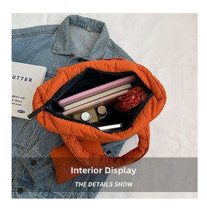 Internal view of the large capacity quilted orange puffer tote bag showing spacious interior