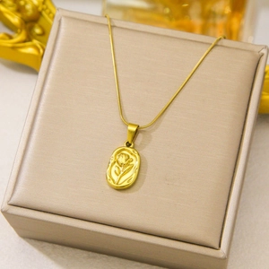Elegant gold rose flower embossed oval pendant necklace on jewelry storage box