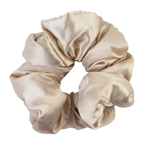 Champagne gold satin oversized scrunchie with silky texture and soft padded design
