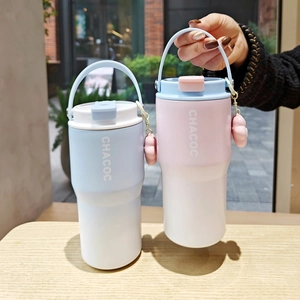 Close-up of matte vacuum insulated coffee mugs with portable handles and cute charms