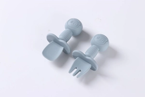 Detail of baby silicone spoon and fork set with safety shield and ergonomic grip
