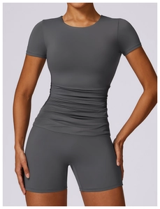 Detail of grey quick-dry yoga set featuring slim fit short sleeve top and high waist shorts