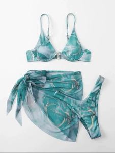 Detailed flat lay of three-piece marble print bikini set with matching mesh sarong wrap