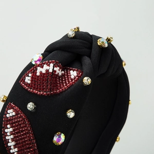 Fashionable black knotted headband with beaded rugby patterns and sparkling rhinestones