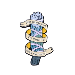 Punk style enamel pin featuring a blue sage bundle and humorous text ribbon