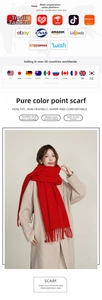 Close-up detail of soft red cashmere scarf with colorful polka dots and tassels