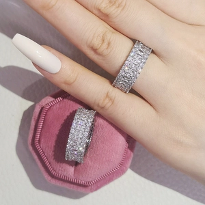 Detailed close-up of luxury eternity ring with baguette-cut zircon in a velvet box