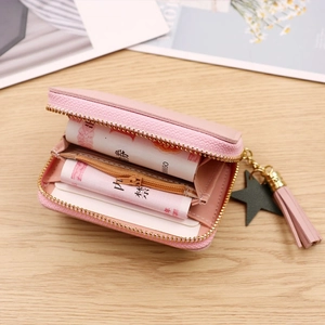 Pink PU leather short wallet with tassel and star charm shown open with cash and card slots