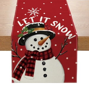 Festive Christmas table runner featuring snowmen and cardinal birds on a rustic wood background