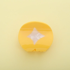 Elegant yellow acetate shark clip with pearlescent diamond pattern for festive hair styling