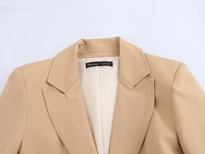 Detail of slim fit khaki blazer collar showing S size label and premium stitching