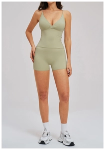 Front view of light green two-piece yoga set featuring v-neck tank top and biker shorts