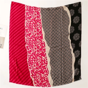 Detailed macro view of mixed floral and animal print patchwork scarf with frayed edges