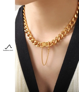 Detail of gold-plated stainless steel cuban chain necklace with secure box clasp