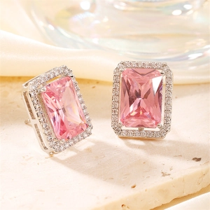 Macro shot of rectangular pink zircon earring with silver metal halo setting