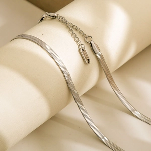 Close-up of silver stainless steel snake chain with lobster clasp and S.STEEL tag