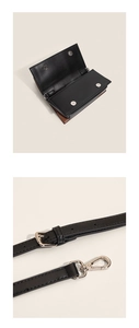 Detail of the magnetic buckle closure and adjustable shoulder strap on the contrast crossbody bag