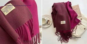 Detail of burgundy and rose purple cashmere-feel scarf showing soft fringe and logo label