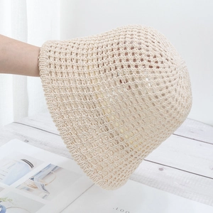 Close-up of the breathable hollow knit texture on a beige handmade straw bucket hat