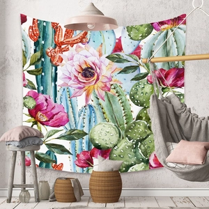 Detail of bohemian cactus and floral tapestry hanging in a cozy living room setup