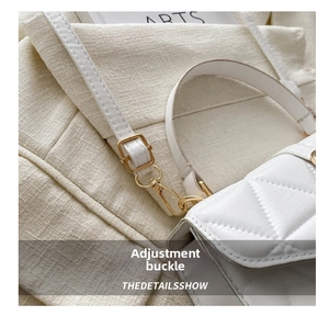 Detail of white quilted crossbody bag with golden metal adjustment buckle and leather strap