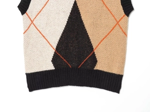 Detailed view of the ribbed hem and diamond knit pattern on this vest
