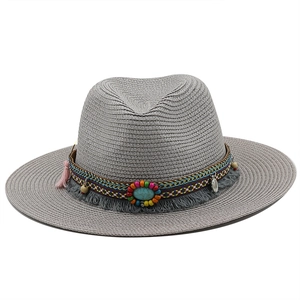 Detail of grey straw fedora hat with ethnic woven band and turquoise bead accent