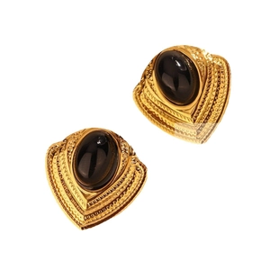 Vintage style gold heart earrings with large black oval gemstones in a 45-degree view
