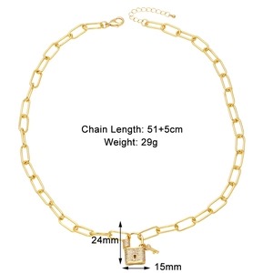 Detail of gold paperclip chain necklace with micro-pave zircon lock and key pendant