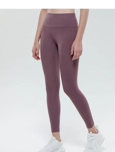 Close-up of high-waisted yoga leggings in dark purple with seamless peach-lift design