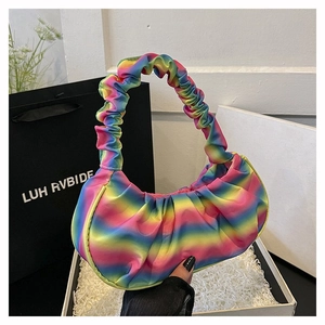 Detailed view of rainbow gradient pleated shoulder bag with satin texture on gift box