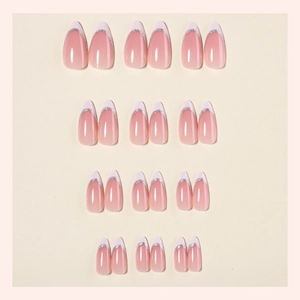 French almond press-on nails with nude base, white tips and silver glitter accents