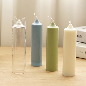 Transparent church top candle mold with blue, green and beige pillar candles on table