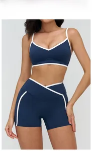 Detail of badge blue sports bra and shorts set with white trim and v-neckline