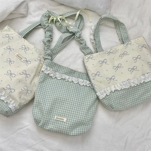 Detail of blue plaid canvas bags with white lace trim and purple ribbon prints