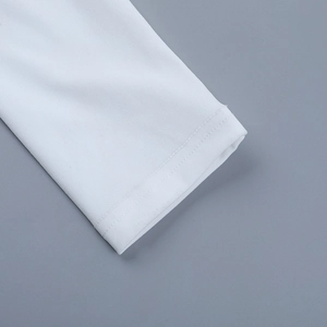 Close-up of sleeve cuff detailing exquisite stitching and white fabric texture on the dress