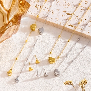 Minimalist heart jewelry set with 18K gold and silver necklaces and matching stud earrings