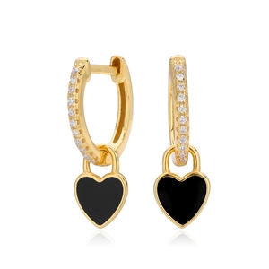 Close-up of gold heart earrings with black enamel and sparkling zircon pavé