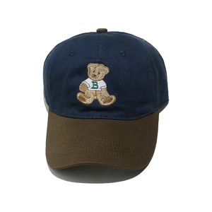 Detail of navy and brown baseball cap featuring a cute embroidered bear with letter B