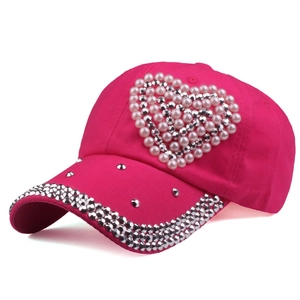 Rose pink baseball cap with heart pearl pattern and rhinestone brim side view