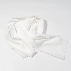 Detailed view of the smooth white satin fabric and elegant drape of the dress necktie